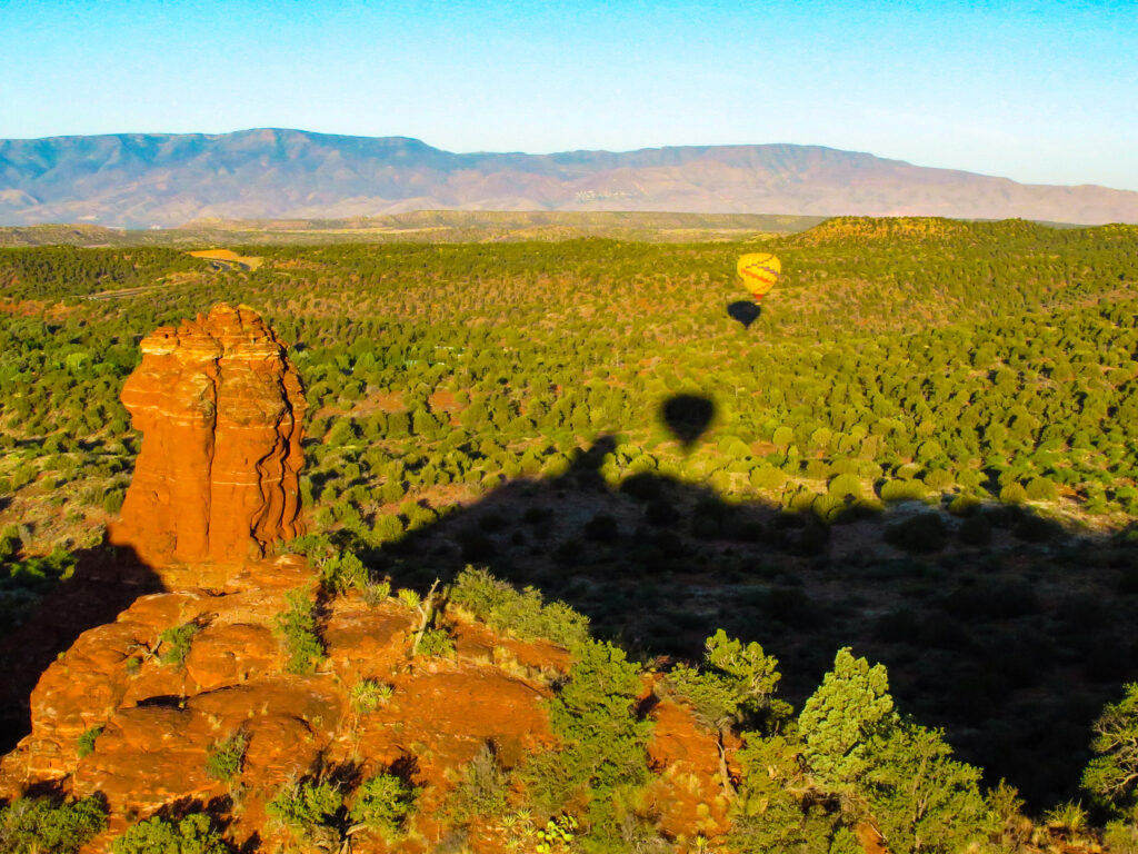 Hot air balloon soaring over the red rocks of Sedona, Arizona
