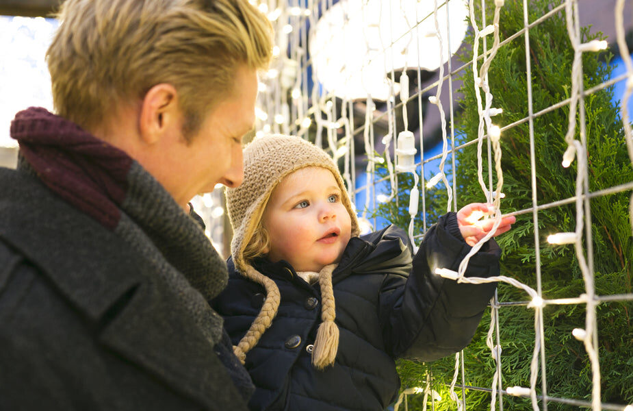 Father and daughter enjoy looking at lights while celbrating Christmas in Oaks, PA
