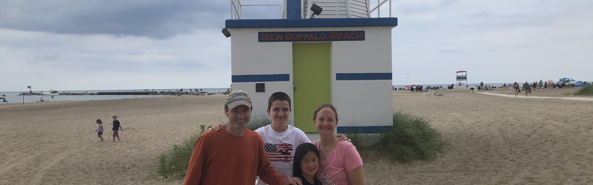 Author's family standing in front of the lighthouse at New Buffalo Beach, Michigan.