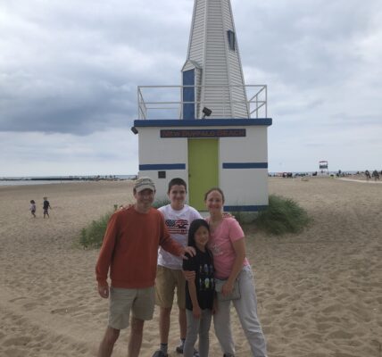 Author's family standing in front of the lighthouse at New Buffalo Beach, Michigan.
