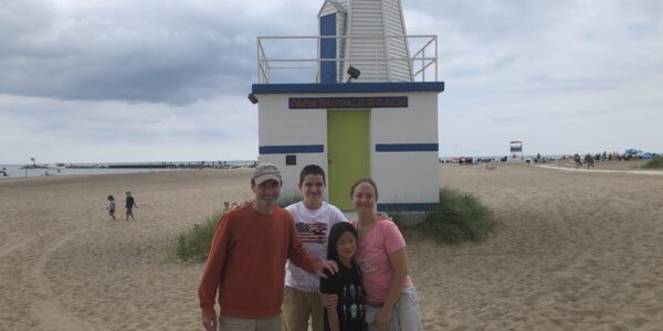 Author's family standing in front of the lighthouse at New Buffalo Beach, Michigan.