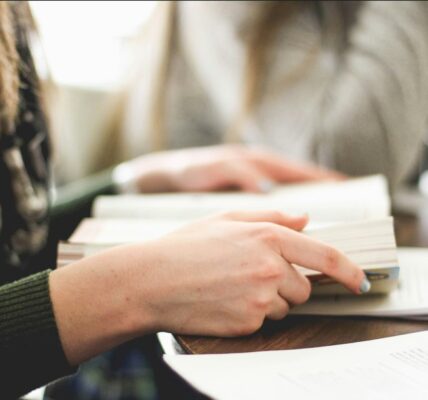 Person holds the Bible open