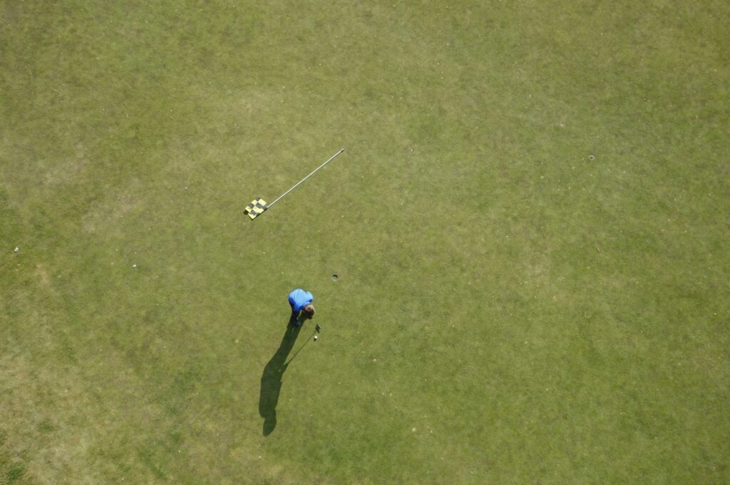 Ariel view of a man taking his final put into the hole