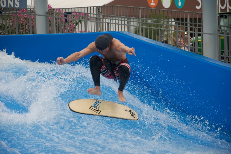 Man rides the flow rider surf simulator.