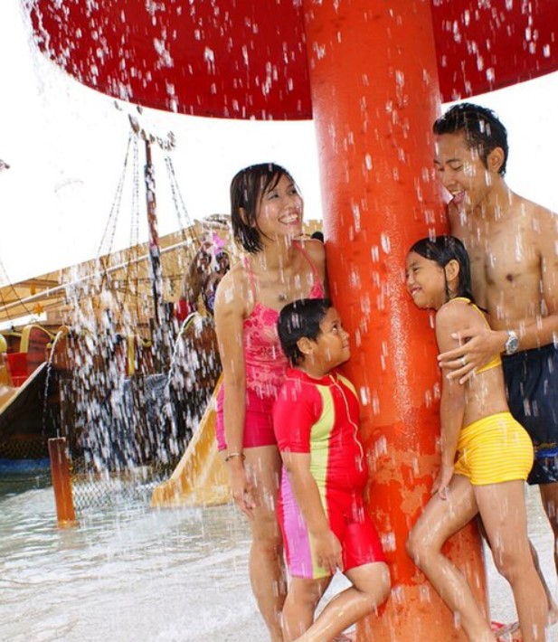 A family enjoys time at a splash pad