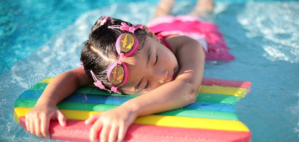 Young Gril enjoys laying on a float at a water park in baton rouge lousinana