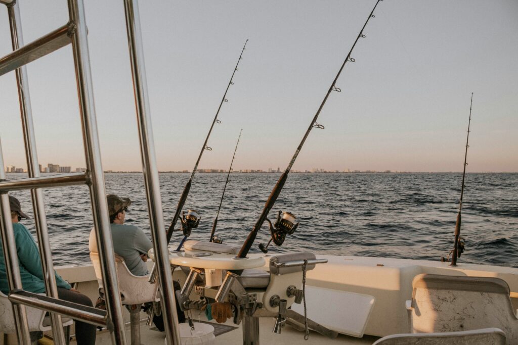 Two men patiently wait for the fish to bit as they enjoy the views of the water on the Alabama Fishing Trips. 