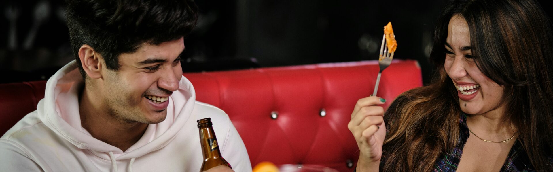 A laughing couple enjoys a meal together at one of the trendy restaurants near dickson street fayetteville ar