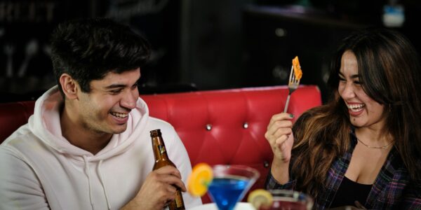 A laughing couple enjoys a meal together at one of the trendy restaurants near dickson street fayetteville ar