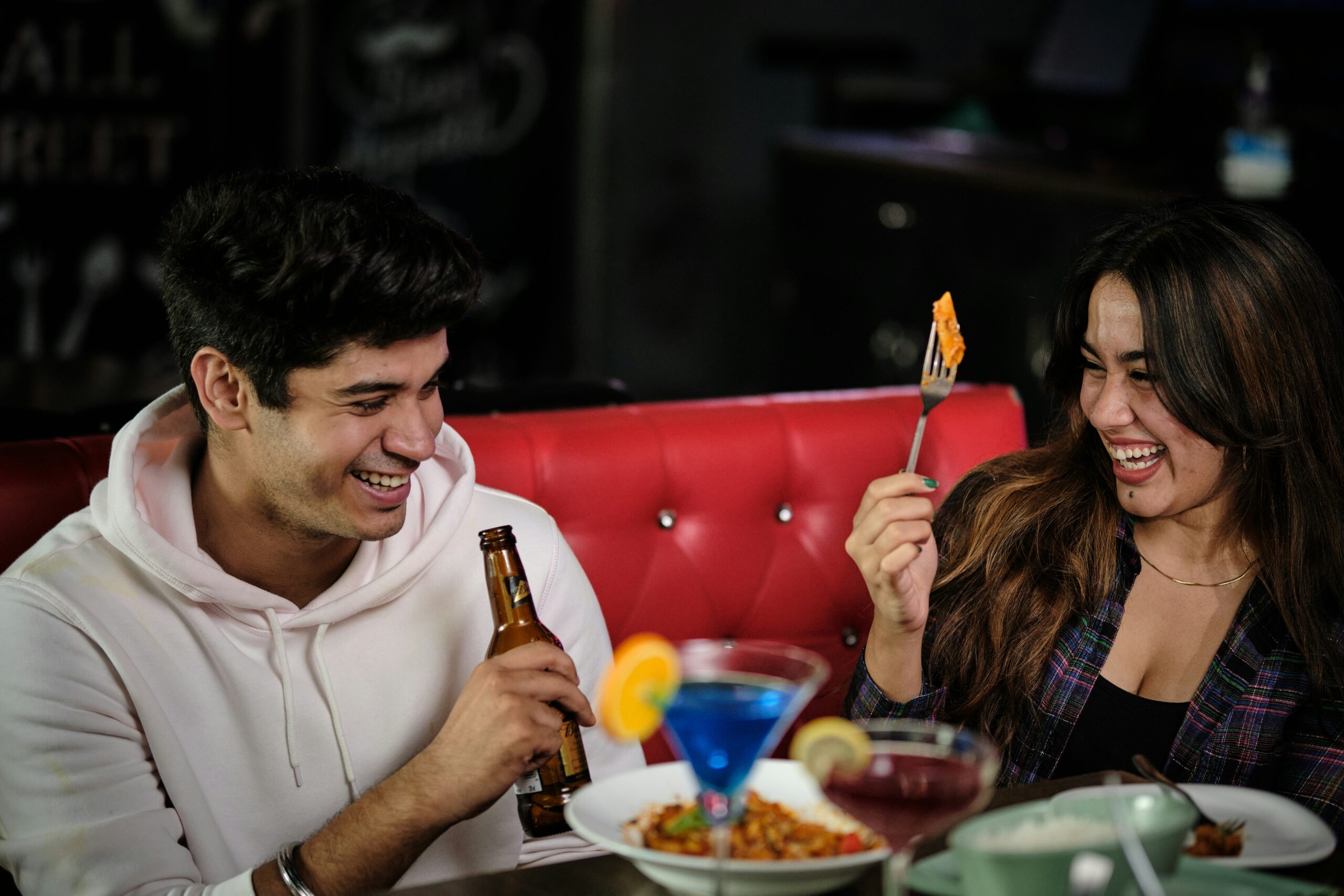 A laughing couple enjoys a meal together at one of the trendy restaurants near dickson street fayetteville ar