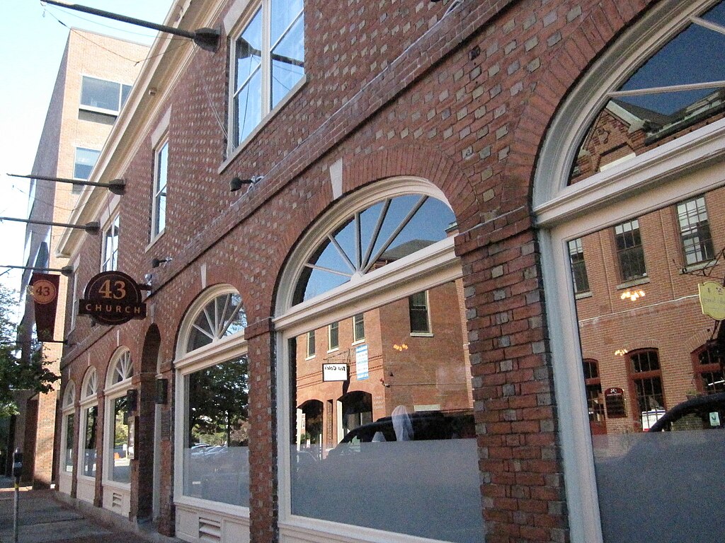 A brick building with large front windows is a replica of the original. 