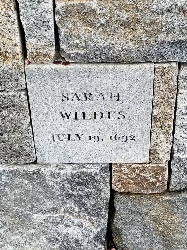 A stone marker for one of the victims lists her name as Sarah Wildes and the date of her death - July 19, 1692.
